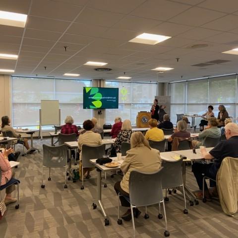 A room of workshop attendees views a presentation